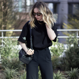 Girl wearing the black sleeve logo tshirt from The Foreign Sun downtown Vancouver.